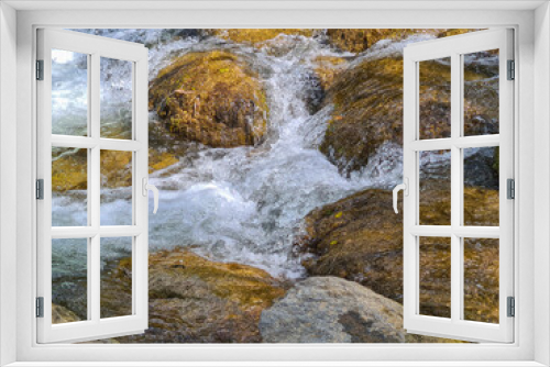 Fototapeta Naklejka Na Ścianę Okno 3D - A waterfall flowing through a large rock