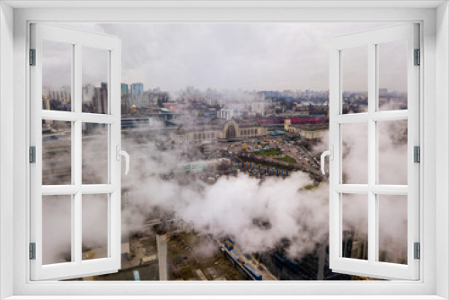 Fototapeta Naklejka Na Ścianę Okno 3D - Aerial drone view. The building of the Kiev railway station through the white smoke from the chimneys.
