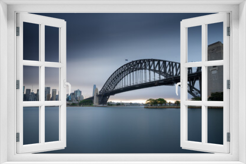 Fototapeta Naklejka Na Ścianę Okno 3D - Sydney Harbour Bridge moody long exposure with smooth water and skyline