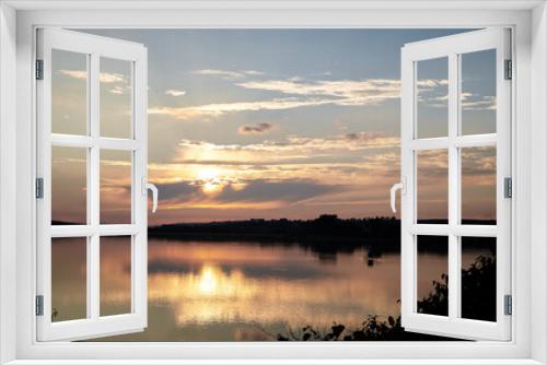 Fototapeta Naklejka Na Ścianę Okno 3D - Beautiful lake view during sunset with blue and yellow sky reflection in water. Rural scene. Ecological protection and eco tourism concept. Natural landscape. Isolation in countryside.