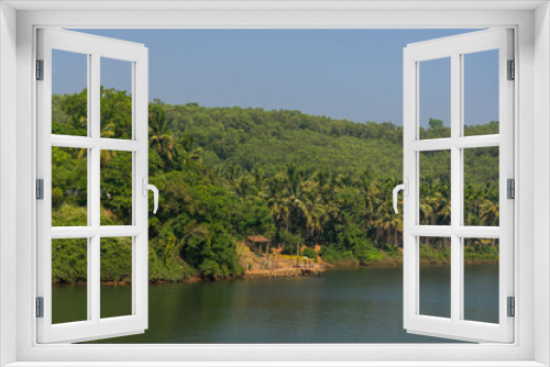 Fototapeta Naklejka Na Ścianę Okno 3D - Panoramic view of dense lush green trees from Divgi Bridge located on Aghanashini river in Karnataka, India