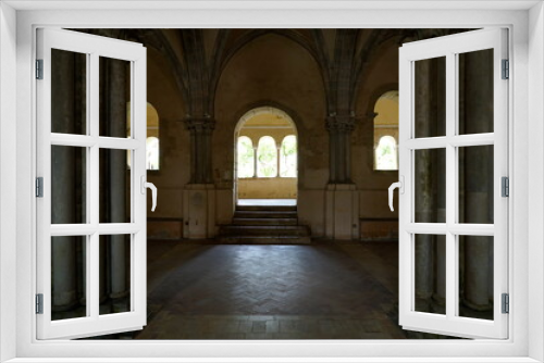 Fototapeta Naklejka Na Ścianę Okno 3D - archi illuminati in controluce chiari e con archi scuri che incorniciano quelli scuri , abbazia medioevale
