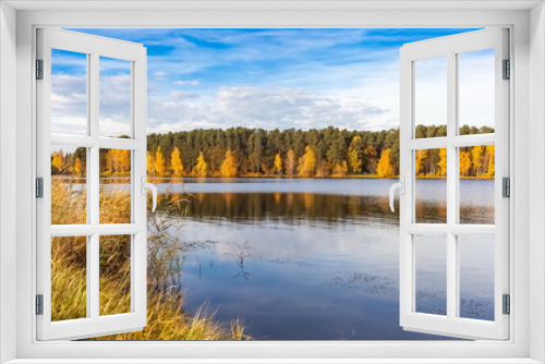 Fototapeta Naklejka Na Ścianę Okno 3D - Lake view, yellow and green trees, blue sky with white clouds in autumn