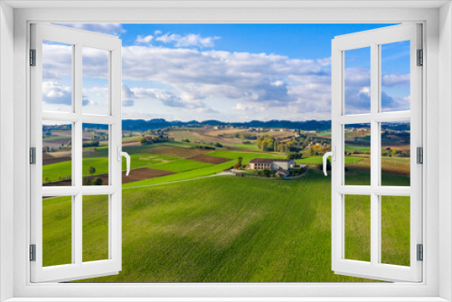 Fototapeta Naklejka Na Ścianę Okno 3D - Aerial view of Monferrato countryside, Italian landscape with bright colors. Rural estate in the middle of green fields, scenic sky, copy space