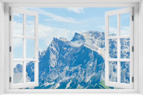 Fototapeta Naklejka Na Ścianę Okno 3D - Die Zugspitze inklusive Berg Station von der Tiroler Seite aus gesehen an einem bewölkten schönen Sommertag
