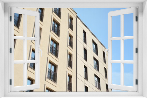 Fototapeta Naklejka Na Ścianę Okno 3D - Fragment of modern luxury residential apartment,  home house building concept. Modern apartment building on a sunny day with a blue sky.