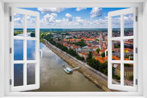 Fototapeta Naklejka Na Ścianę Okno 3D - Szeged, Hungary - Aerial view of the Votive Church and Cathedral of Our Lady of Hungary (Szeged Dom) and River Tisza on a sunny summer day with blue sky and clouds