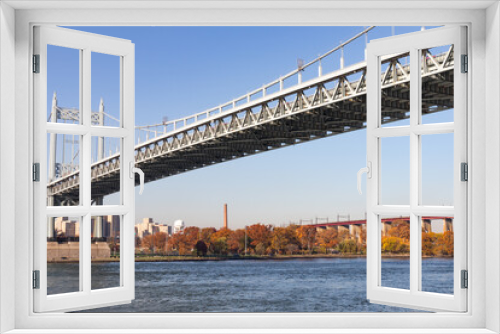 Fototapeta Naklejka Na Ścianę Okno 3D - The Triborough Bridge over the East River with the Shore of Randalls and Wards Islands during Autumn with Colorful Trees in New York City