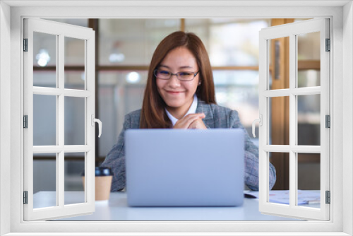 Closeup image of a beautiful businesswoman using laptop computer for working online and video conference