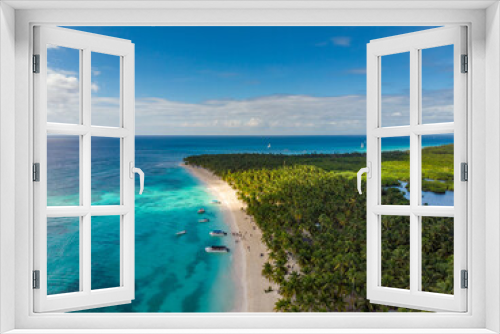 Fototapeta Naklejka Na Ścianę Okno 3D - Aerial drone view of the paradise beach with palm trees, boats, sun beds, coral reef and blue water of Caribbean Sea, Saona island, Dominican Republic