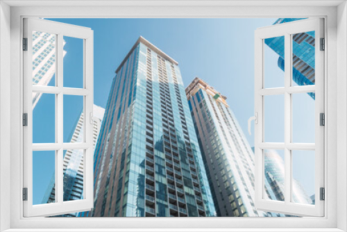 View from below of tall blue skyscrapers in the city of Montreal