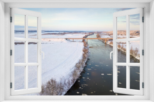 Fototapeta Naklejka Na Ścianę Okno 3D - Bridge over the Dnieper River, snowy forest on a beautiful winter day with blue sky and clouds. Beautiful winter landscape