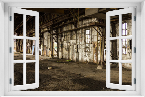 Fototapeta Naklejka Na Ścianę Okno 3D - Long brick wall with various openings in an abandoned factory in the deep south