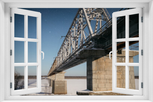 Fototapeta Naklejka Na Ścianę Okno 3D - modern railway bridge over the frozen northern river