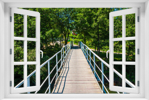Fototapeta Naklejka Na Ścianę Okno 3D - small bridge with a metal railing over a mountain river