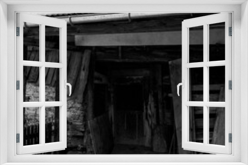 Fototapeta Naklejka Na Ścianę Okno 3D - Entrance of a old log hut for animal shelters in the Swiss village of Alvaneu, shot with analogue photography technique