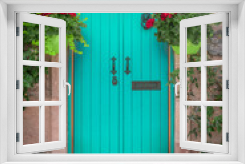 Fototapeta Naklejka Na Ścianę Okno 3D - Vibrant Blue Cottage Door With Colourful Flower Baskets