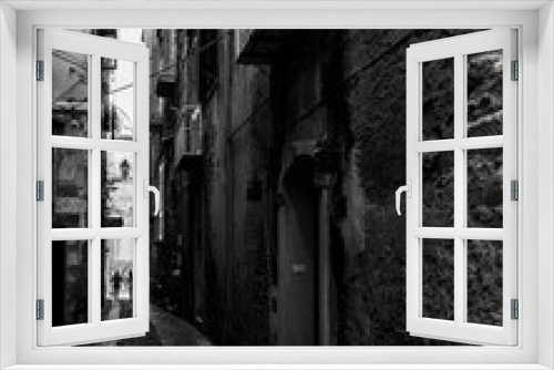 Fototapeta Naklejka Na Ścianę Okno 3D - Black and white image of a narrow alley in Tropea historic center, Calabria, Italy