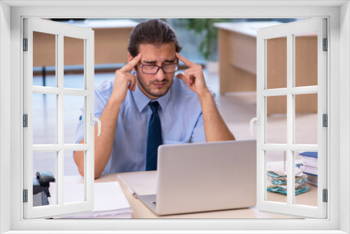 Young male accountant working in the office