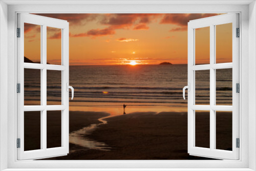 Fototapeta Naklejka Na Ścianę Okno 3D - Surfer looking out to sea at sunset in Cornwall. Beach with surfer holding surfboard in Summer. Cornish beach surfer. 