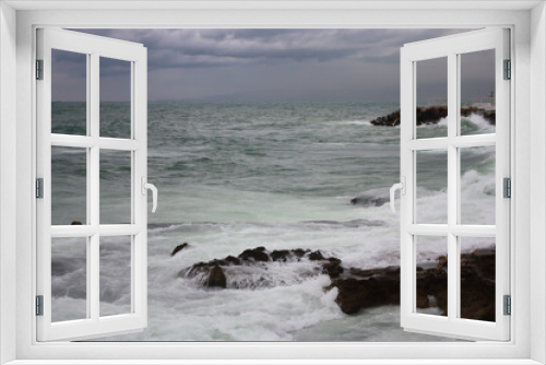 Fototapeta Naklejka Na Ścianę Okno 3D - Mediterranean Sea waves washing over rocks on the shore in Beirut, Lebanon, in stormy weather