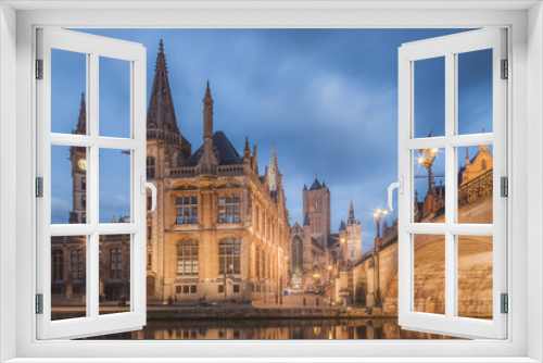 The beautiful historic old town of Ghent, Belgium along the Leie Canal at dusk.