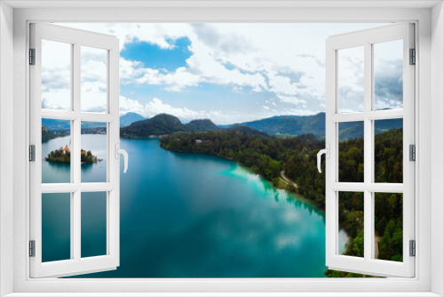 Fototapeta Naklejka Na Ścianę Okno 3D - Aerial large wide panoramic view of Lake Bled. Cloudy weather, heavy thunderstorm clouds on the horizon. Summer day. Season of tour and travel. Church of the Mother of God, Slovenia, Europe