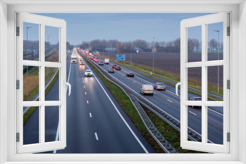 Fototapeta Naklejka Na Ścianę Okno 3D - Cars driving in the evening on the A44 highway to the village of Sassenheim, Abbenes and Kaag in the Netherlands.