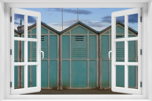 Fototapeta Naklejka Na Ścianę Okno 3D - Blue beach sheds on the sand in a winter day (Pesaro, Italy, Europe)