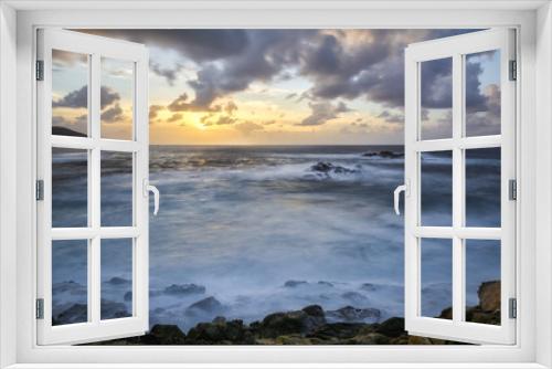 Fototapeta Naklejka Na Ścianę Okno 3D - Sunset over the wild blue ocean