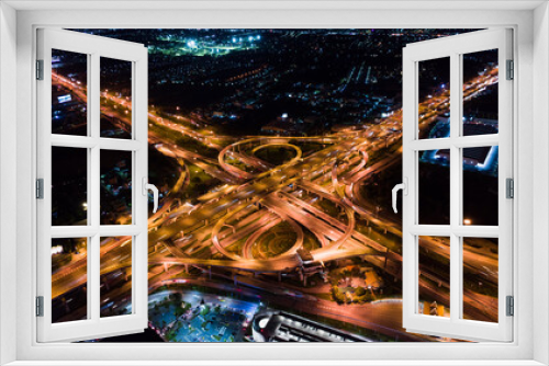Fototapeta Naklejka Na Ścianę Okno 3D - Car traffic transport on multiple lane highway or winding road expressway in Asia city at night, drone aerial view, high angle. Civil engineering technology, Asian transportation concept