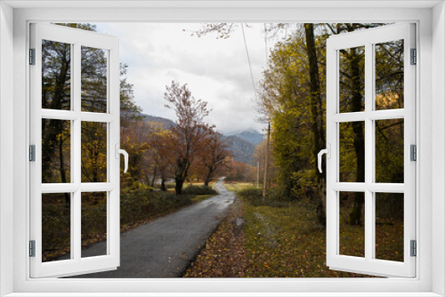 Fototapeta Naklejka Na Ścianę Okno 3D - Amazing view with colorful autumn forest with asphalt mountain road at sunset.