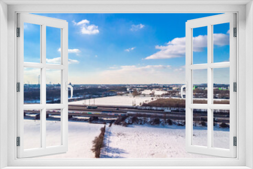 Fototapeta Naklejka Na Ścianę Okno 3D - View of the snow-covered skyline of Duisburg on a sunny winter day from above