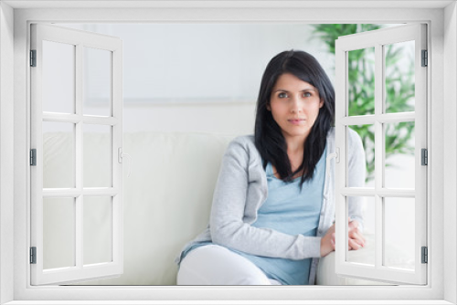 Woman sitting on the end of a couch