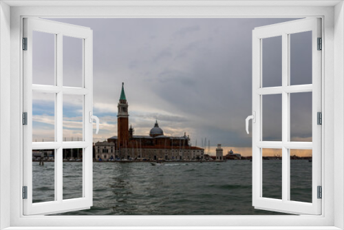 Venice's canal, boat and traditional Venetian houses view.	