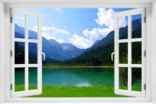 Fototapeta Naklejka Na Ścianę Okno 3D - Alpensee unter blauem Himmel