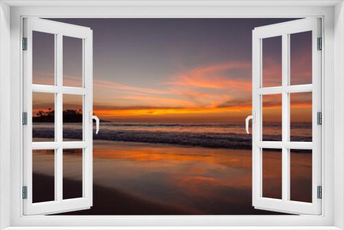 Fototapeta Naklejka Na Ścianę Okno 3D - Tropical summer calm sunset landscape at the beach with sand, water, ocean waves, sky with orange curved clouds reflected on the sand, Flamingo Beach, Guanacaste, Costa Rica