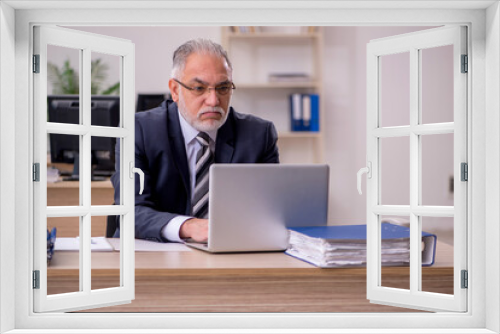 Aged businessman employee sitting in the office