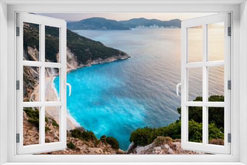 Fototapeta Naklejka Na Ścianę Okno 3D - The popular Myrtos beach on the Greek island of Kefalonia, Ionian Sea, during sunset with fluorescent, blue sea