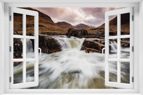 Fototapeta Naklejka Na Ścianę Okno 3D - long exposure image of the river etive and waterfalls in glen etive during winter showing flowing water moving over dark rock with scottish mountains in the background