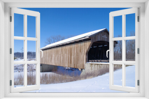 Fototapeta Naklejka Na Ścianę Okno 3D - Wooden covered bridge in snow