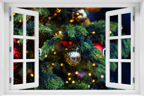 Fototapeta Naklejka Na Ścianę Okno 3D - Decorated Christmas tree on blurred background. New Year's and Christmas holiday background with lights on tree.