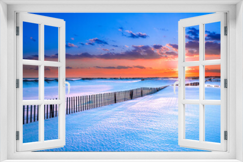 Fototapeta Naklejka Na Ścianę Okno 3D - Winter scene under color sky at sunset on snow covered beach. Jones Beach State Park., Long Island NY