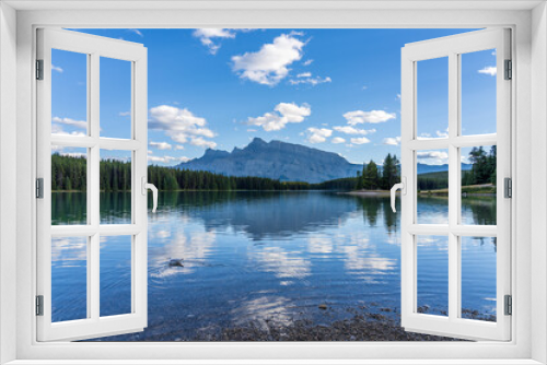 Fototapeta Naklejka Na Ścianę Okno 3D - Two Jack Lake beautiful landscape in summer day. Mount Rundle with blue sky, white clouds reflected on water surface. Banff National Park, Canadian Rockies, Alberta, Canada.