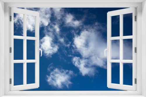 White clouds on a background of blue sky. Summer cloudy day.