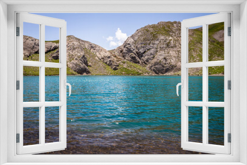 Fototapeta Naklejka Na Ścianę Okno 3D - Panoramic view of a beautiful lake with turquoise blue water in summer, at the foot of the lake