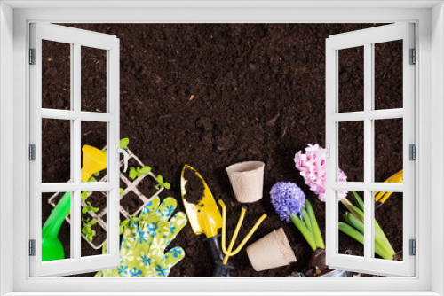 Fototapeta Naklejka Na Ścianę Okno 3D - Gardening tools and flowers on soil background top view.