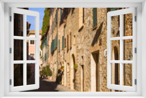 Fototapeta Naklejka Na Ścianę Okno 3D - Narrow street with medieval houses, San Quirico d'Orcia, Italy