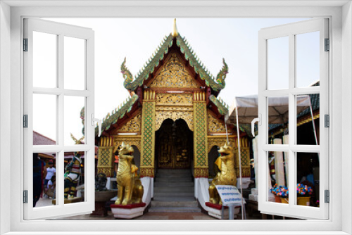 Fototapeta Naklejka Na Ścianę Okno 3D - Ordination hall church or ubosot of Wat Phra That Doi Kham temple for thai people and foreign travelers travel visit and respect praying at Mae Hia city on November 10, 2020 in Chiang Mai, Thailand