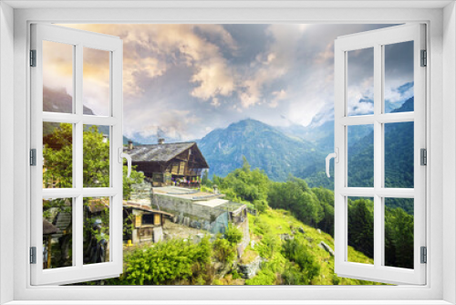 Fototapeta Naklejka Na Ścianę Okno 3D - House on mountain looking down on inspiring view of Alps at sunset